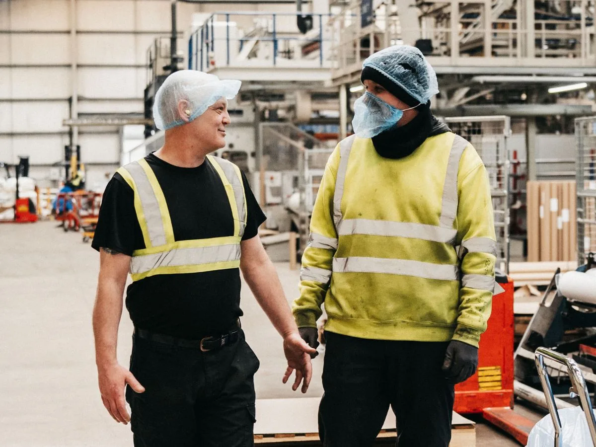 Factory workers in polythene packaging manufacturing facility